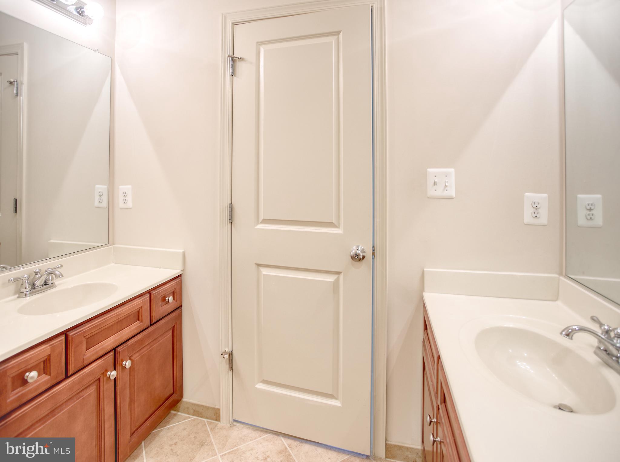 13336 Redspire Drive Silver Spring, MD 20906 - Photo 35 of 66 a bathroom with a sink and a mirror