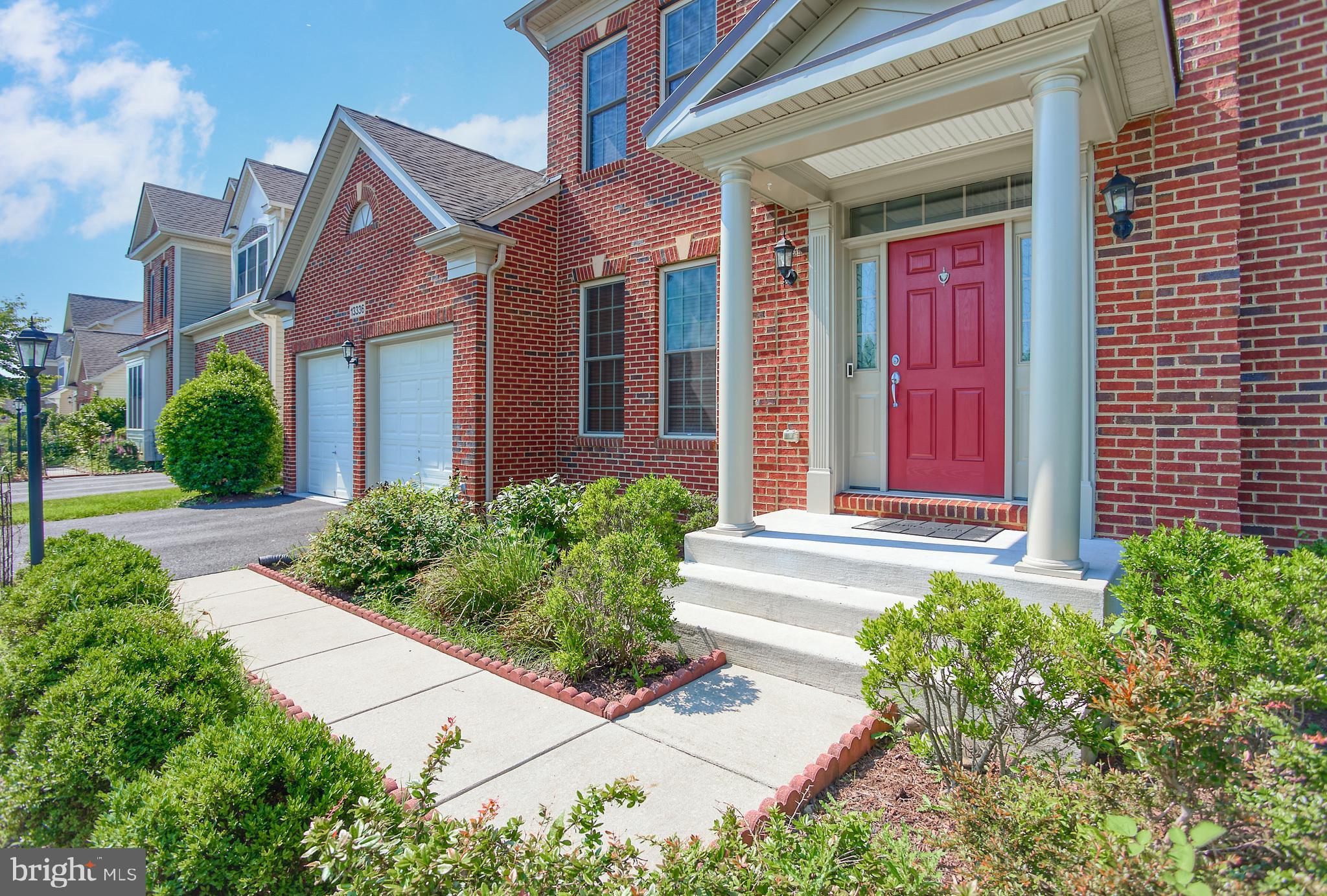 13336 Redspire Drive Silver Spring, MD 20906 - Photo 5 of 66 a front view of brick house with a yard