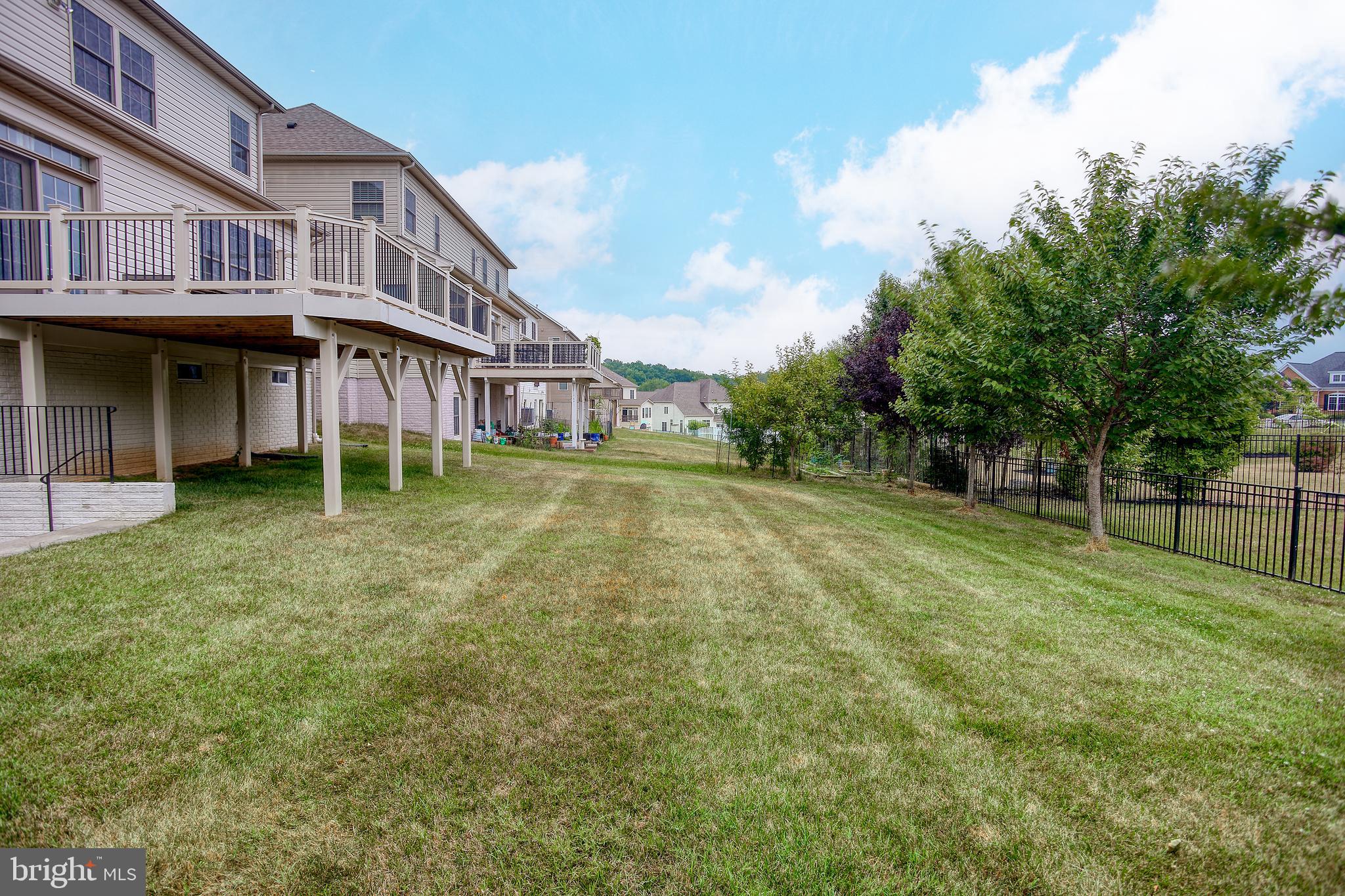 13336 Redspire Drive Silver Spring, MD 20906 - Photo 51 of 66 a backyard of a house with yard and trampoline