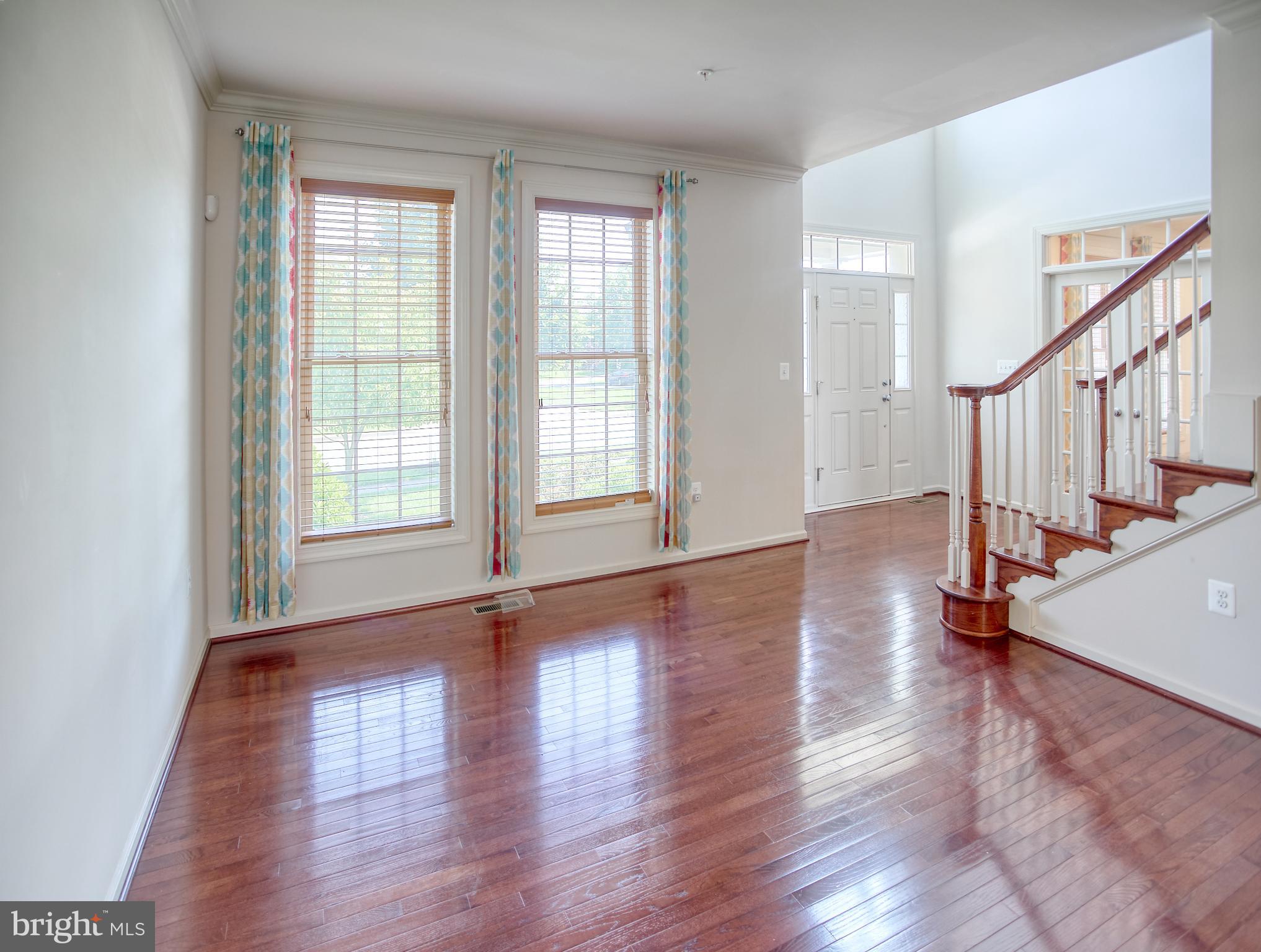 13336 Redspire Drive Silver Spring, MD 20906 - Photo 6 of 66 a view of an empty room with wooden floor and a window