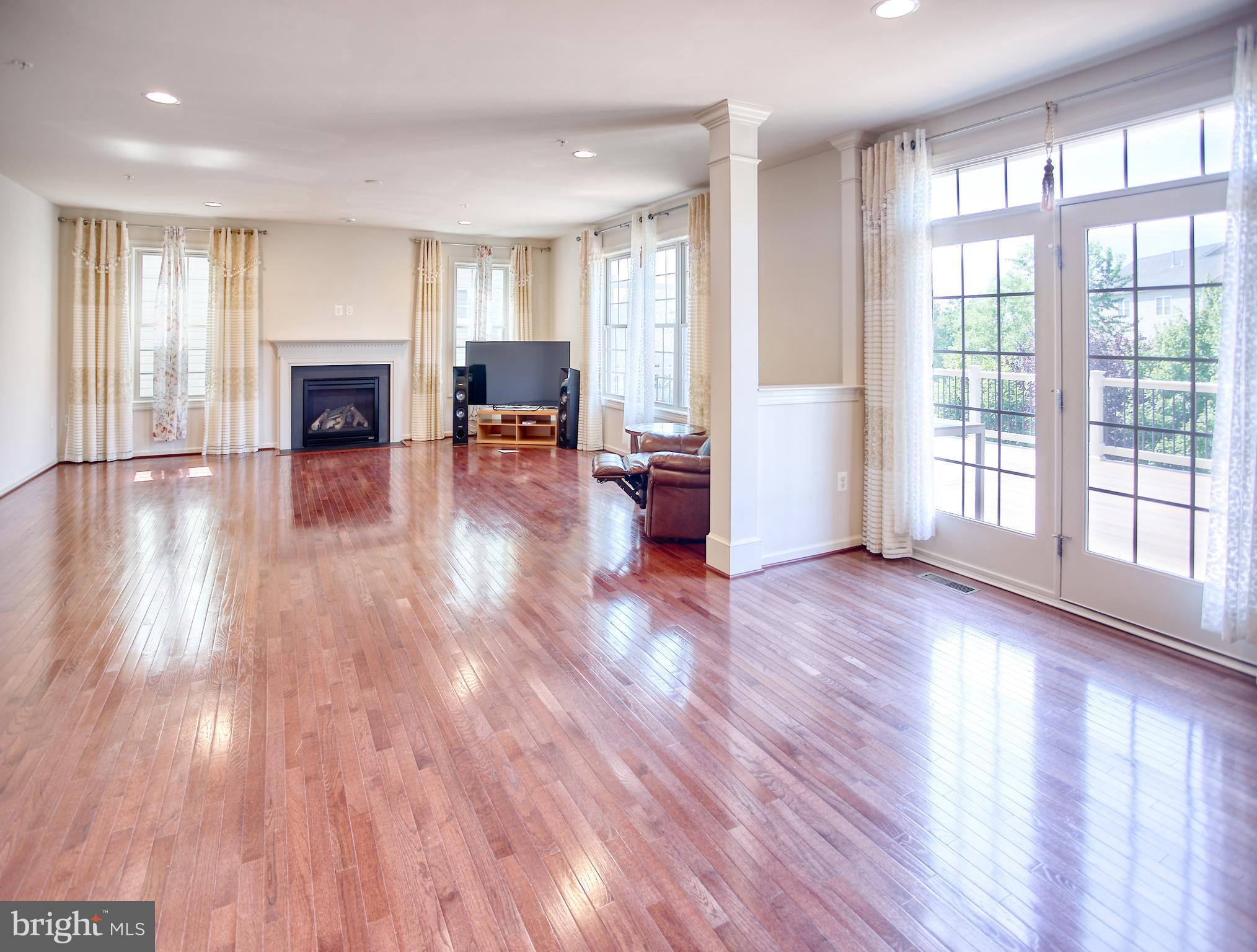 13336 Redspire Drive Silver Spring, MD 20906 - Photo 8 of 66 a view of empty room with wooden floor and fireplace