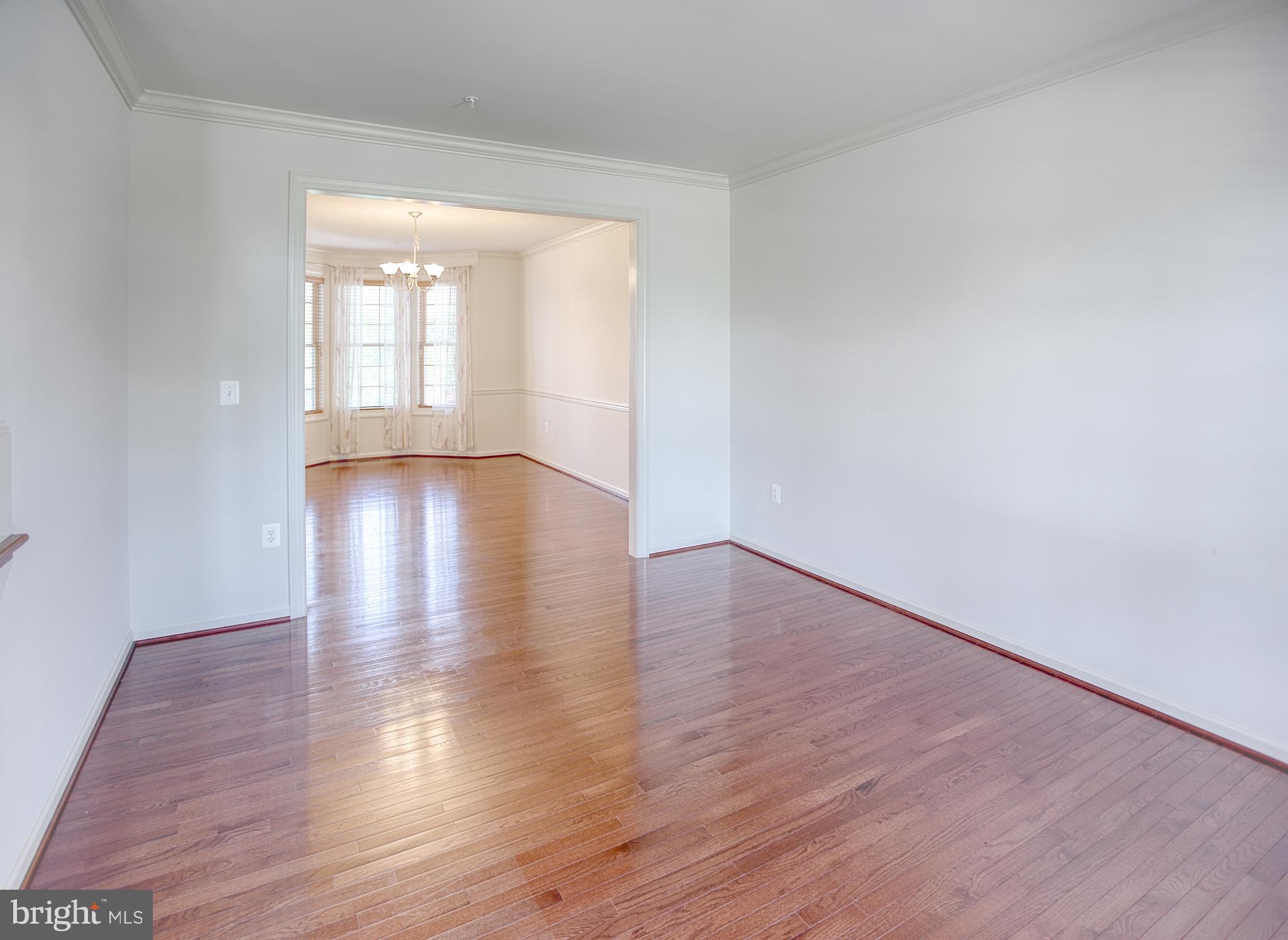 13336 Redspire Drive Silver Spring, MD 20906 - Photo 9 of 66 a view of an empty room with wooden floor and window