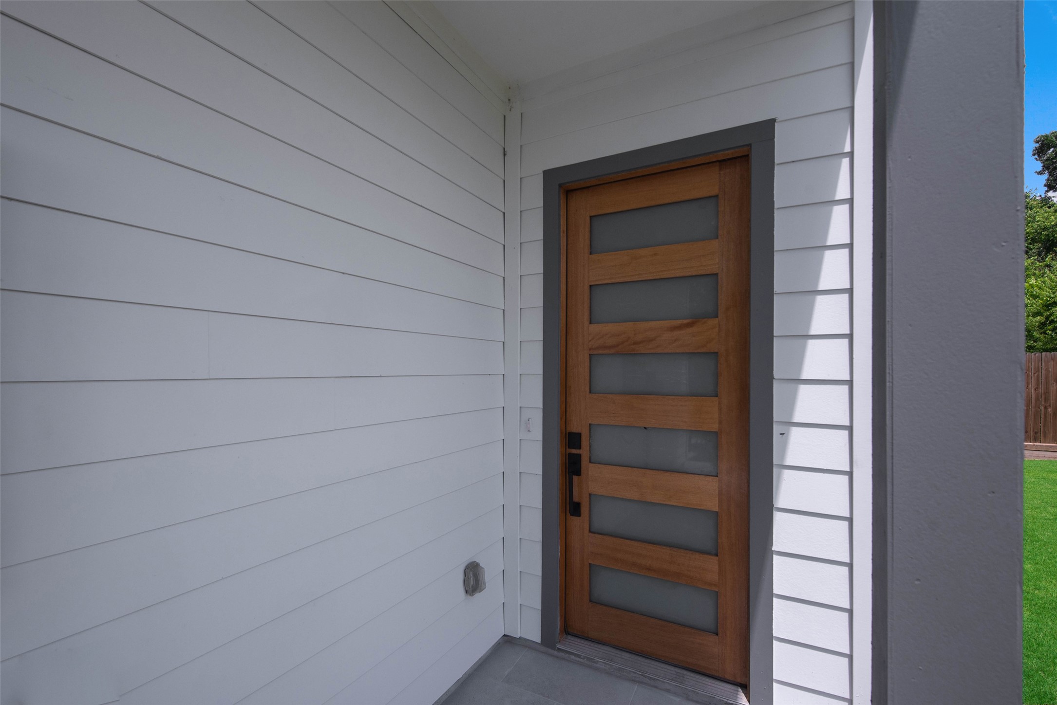 9311 Jutland Road Houston, TX 77033 - Photo 25 of 28 The striking modern entrance with an inviting covered entryway creates a bold yet welcoming first impression.