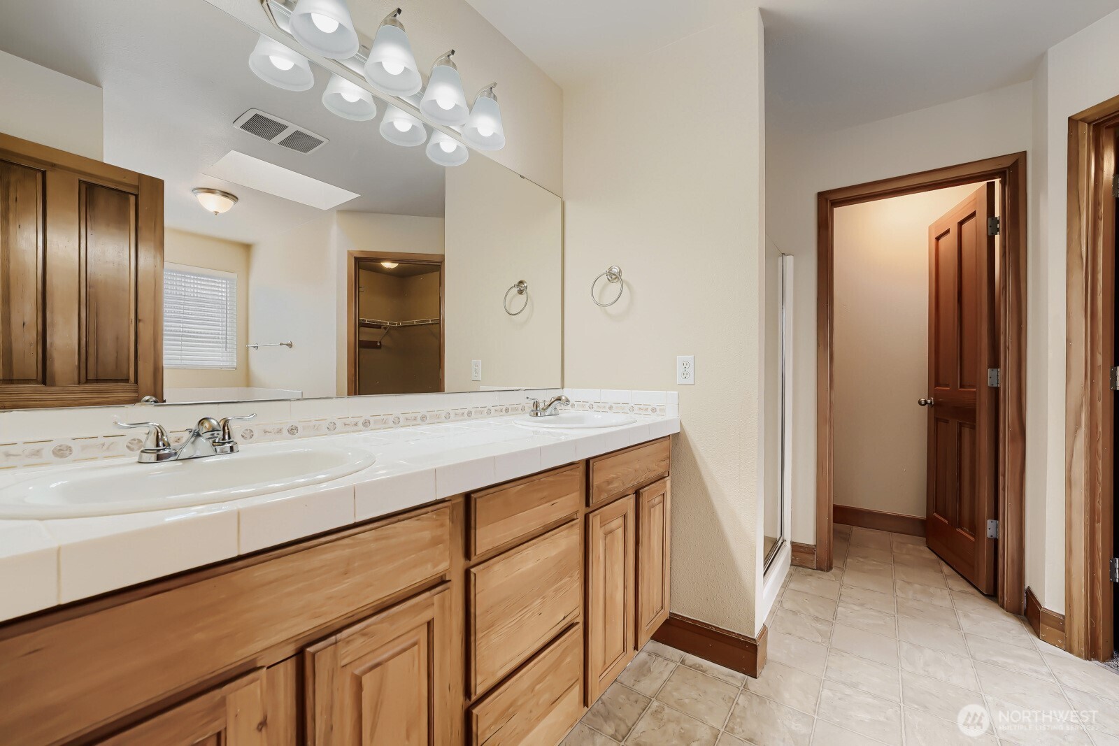 1104 Williams Street Northwest Orting, WA 98360 - Photo 14 of 27 a bathroom with a double vanity sink and a mirror