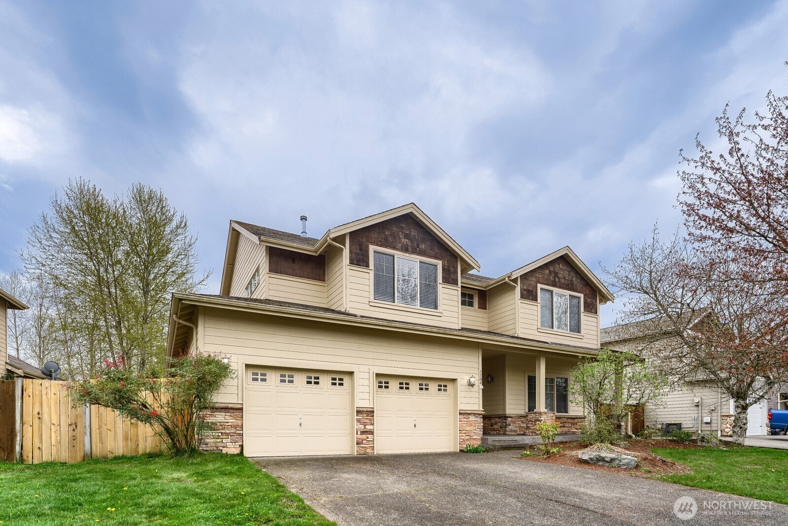 1104 Williams Street Northwest Orting, WA 98360 - Photo 2 of 27 a house that has lot of windows on it and trees in the background