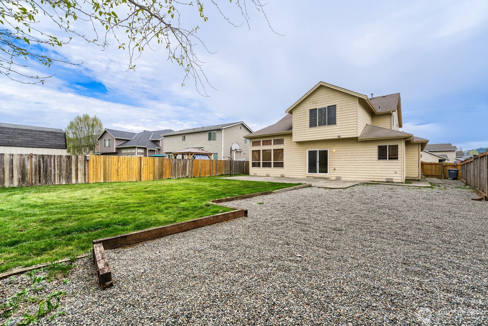 1104 Williams Street Northwest Orting, WA 98360 - Photo 27 of 27 a front view of a house with a yard and garage