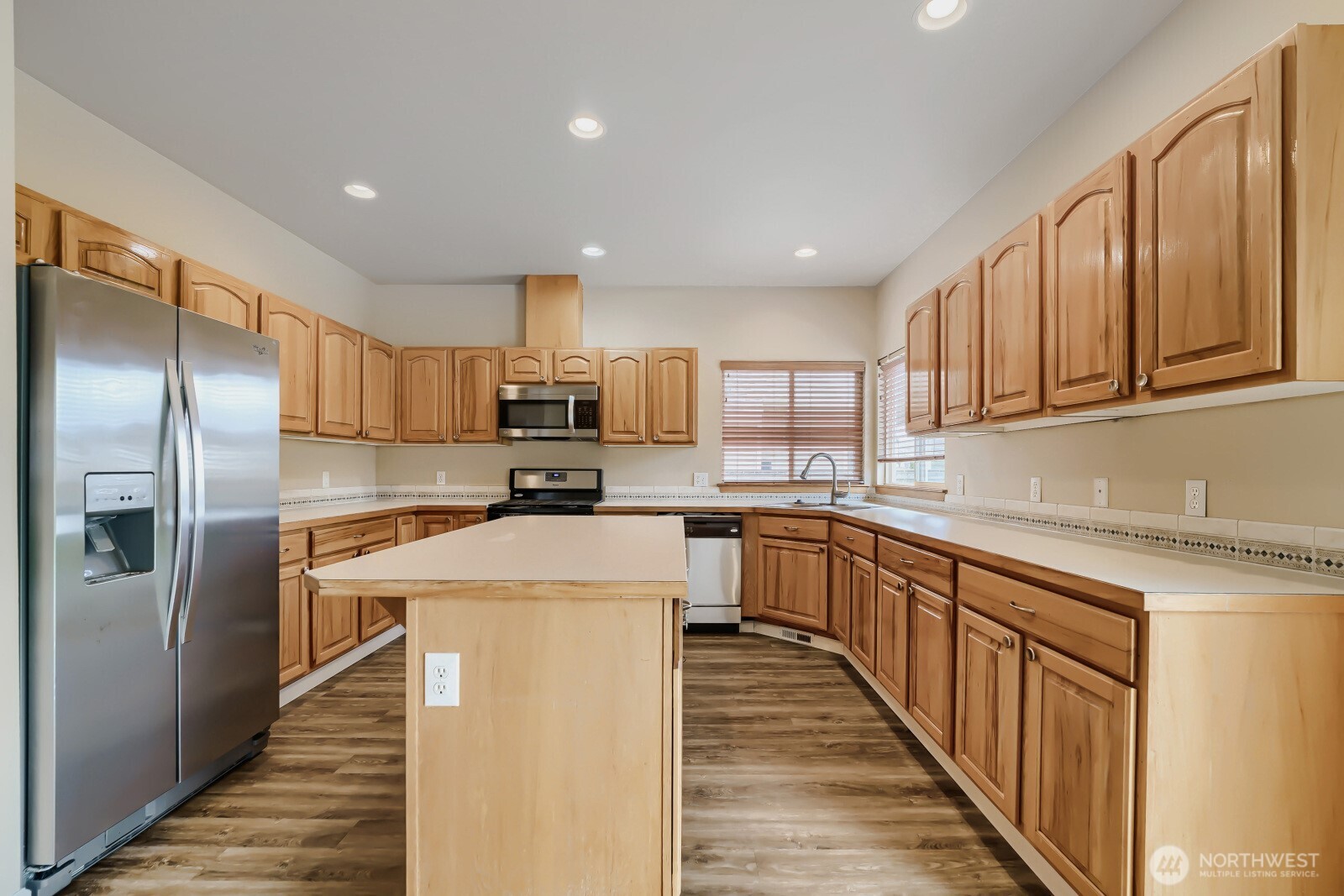 1104 Williams Street Northwest Orting, WA 98360 - Photo 9 of 27 a kitchen with stainless steel appliances granite countertop refrigerator sink and cabinets
