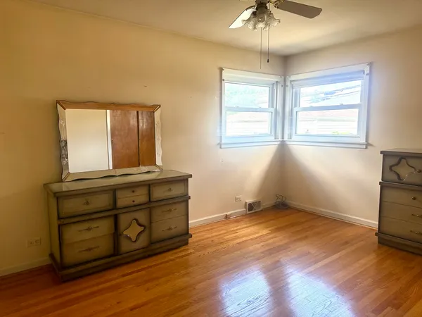 a room with a dresser and a window