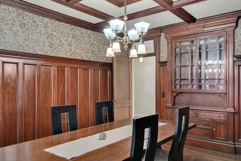 a view of a dining room with furniture and chandelier