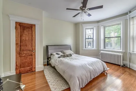 a bedroom with bed and window