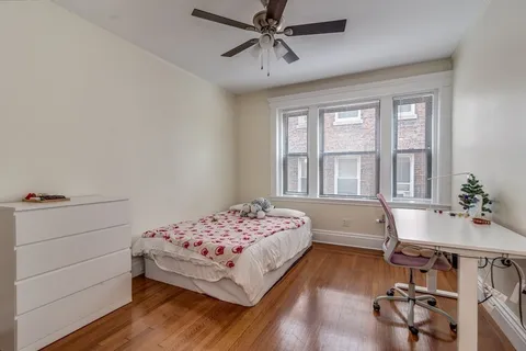 a bedroom with a bed and a desk
