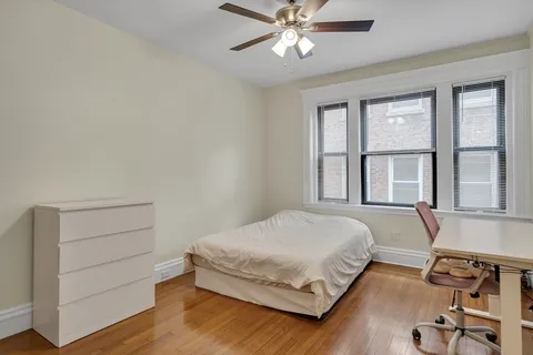 a bedroom with a bed and windows