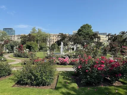 a view of garden with flowers and trees