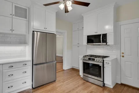 a kitchen with stainless steel appliances a stove a microwave and a refrigerator