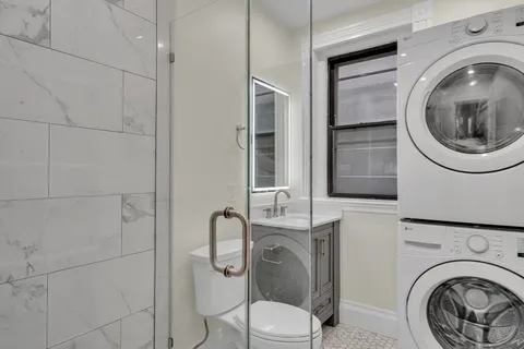 a bathroom with a toilet mirror and vanity