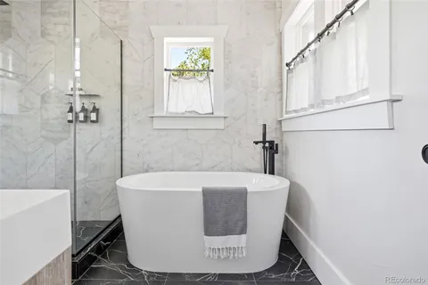 a blue couch sitting in a living room next to a window