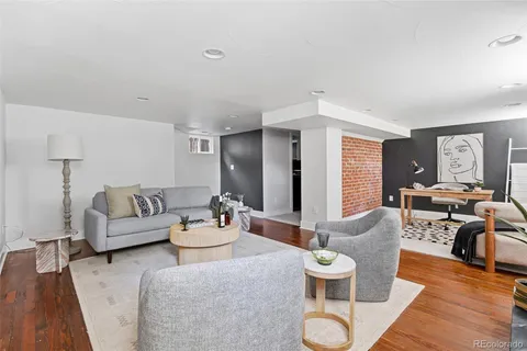 a view of entryway with furniture and wooden floor