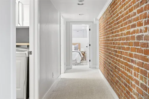 a view of an empty room with wooden floor and a cabinet