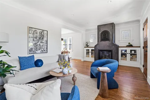 a dining room with furniture a chandelier and wooden floor