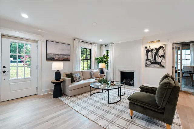 a living room with furniture a fireplace and a window