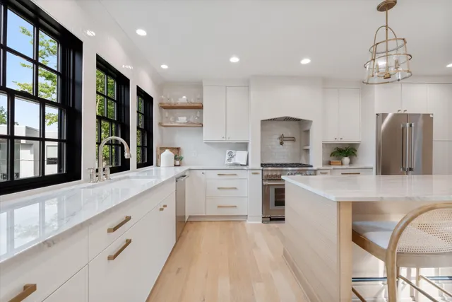 a kitchen with white cabinets and stainless steel appliances