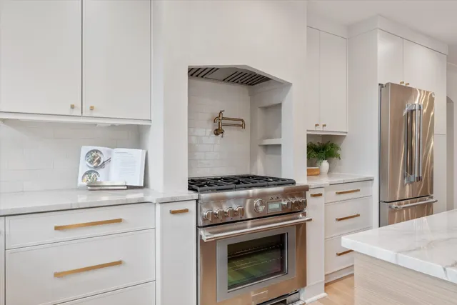 a kitchen with a stove and a refrigerator