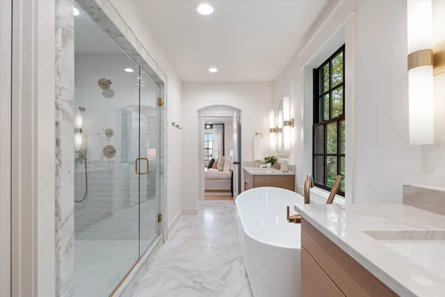 a bathroom with a granite countertop sink mirror and shower
