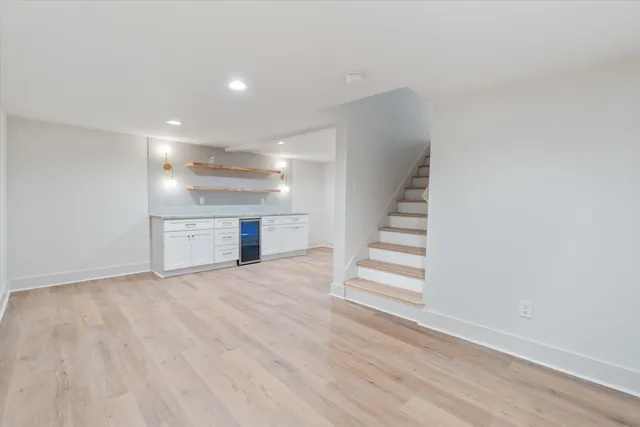 a view of a room with wooden floor and staircase