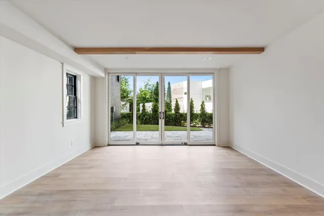 a view of empty room with floor to ceiling window