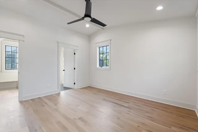 a view of an empty room with wooden floor