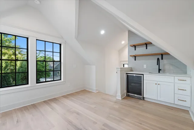 a kitchen with granite countertop a sink stainless steel appliances and cabinets