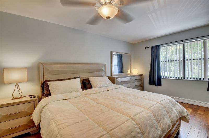 9316 Ketay Circle Boca Raton, FL 33428 - Photo 20 of 30 a bedroom with a bed and a chandelier