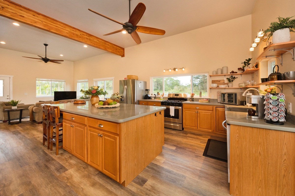 17-3926 Enos Road Mountain View, HI 96771 - Photo 9 of 30 a kitchen with stainless steel appliances granite countertop a sink counter space and wooden floor