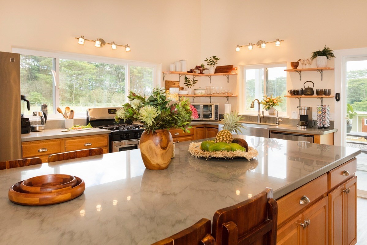 17-3926 Enos Road Mountain View, HI 96771 - Photo 10 of 30 a kitchen with a table chairs and a potted plant