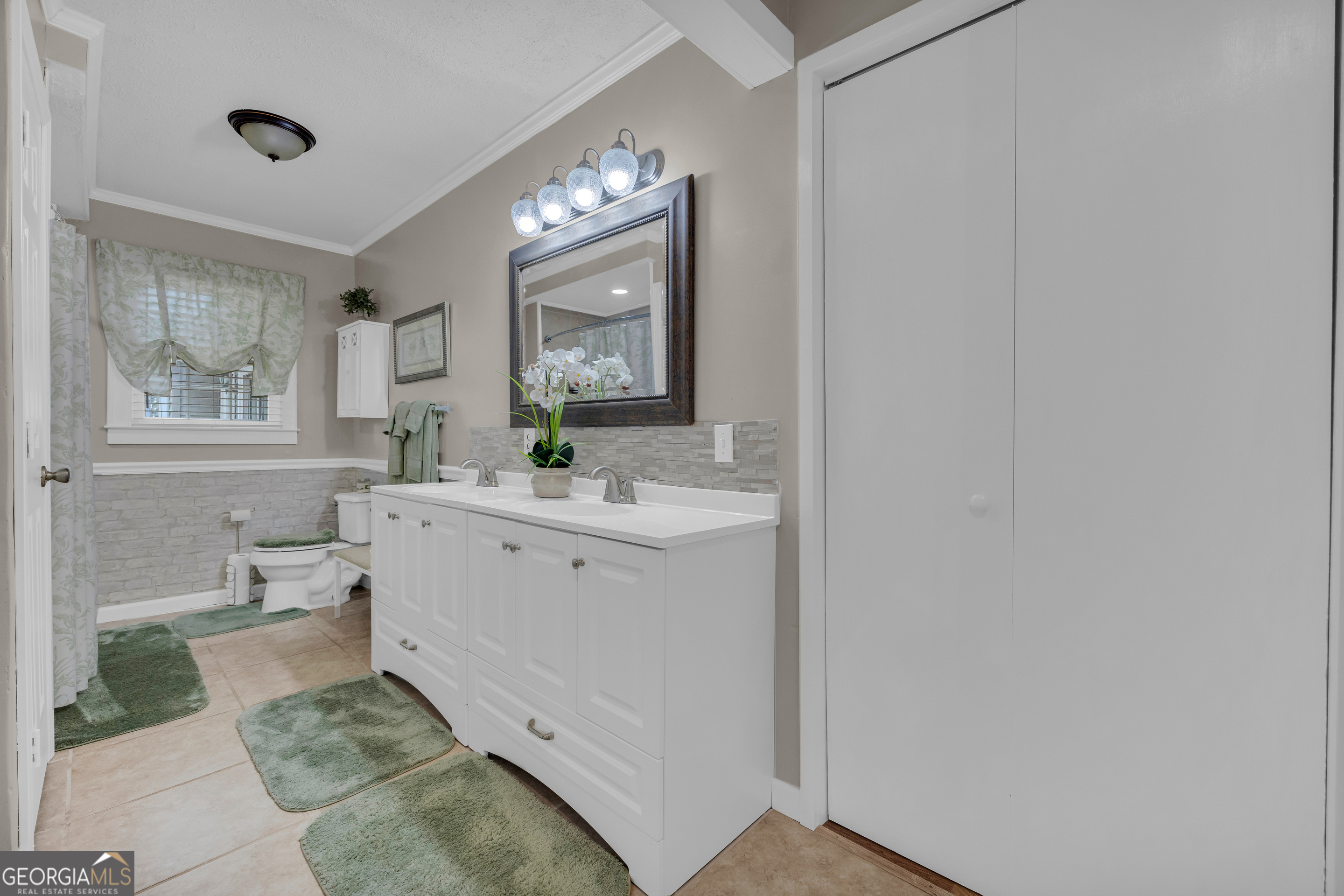 1270 Airline-Goldmine Road Canon, GA 30520 - Photo 22 of 107 a spacious bathroom with a double vanity sink a mirror and a bathtub
