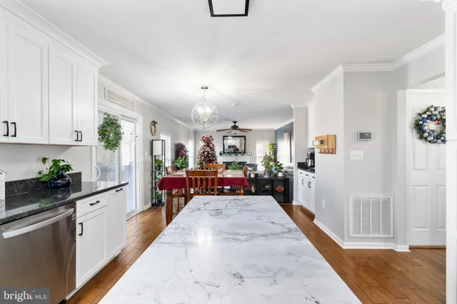 a view of a dining room with furniture wooden floor and chandelier