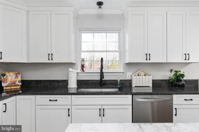 a living room with flowers furniture and a fireplace