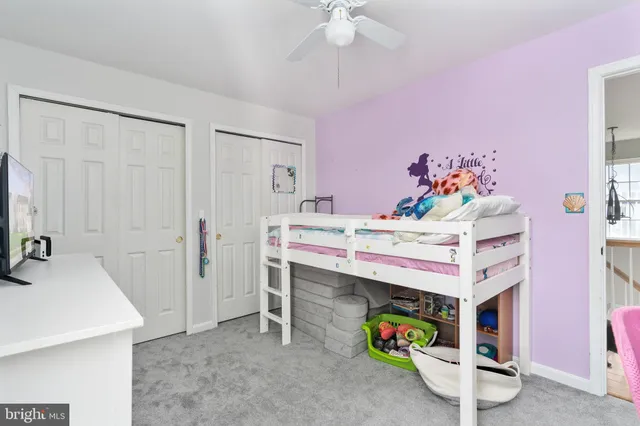 a view of a hallway to a livingroom with furniture and wooden floor