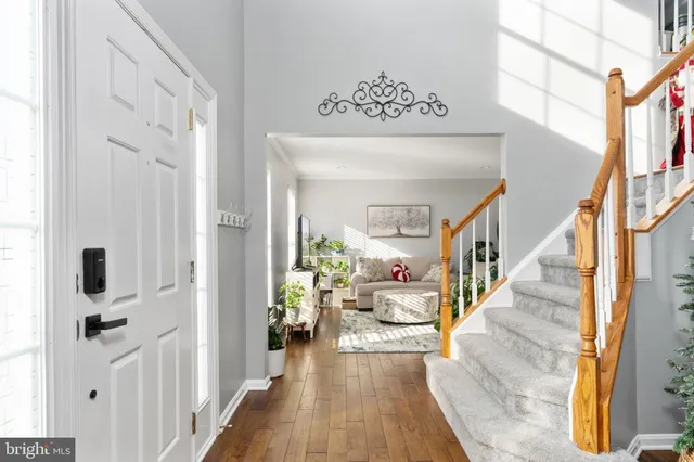 a view of entryway and hall with wooden floor