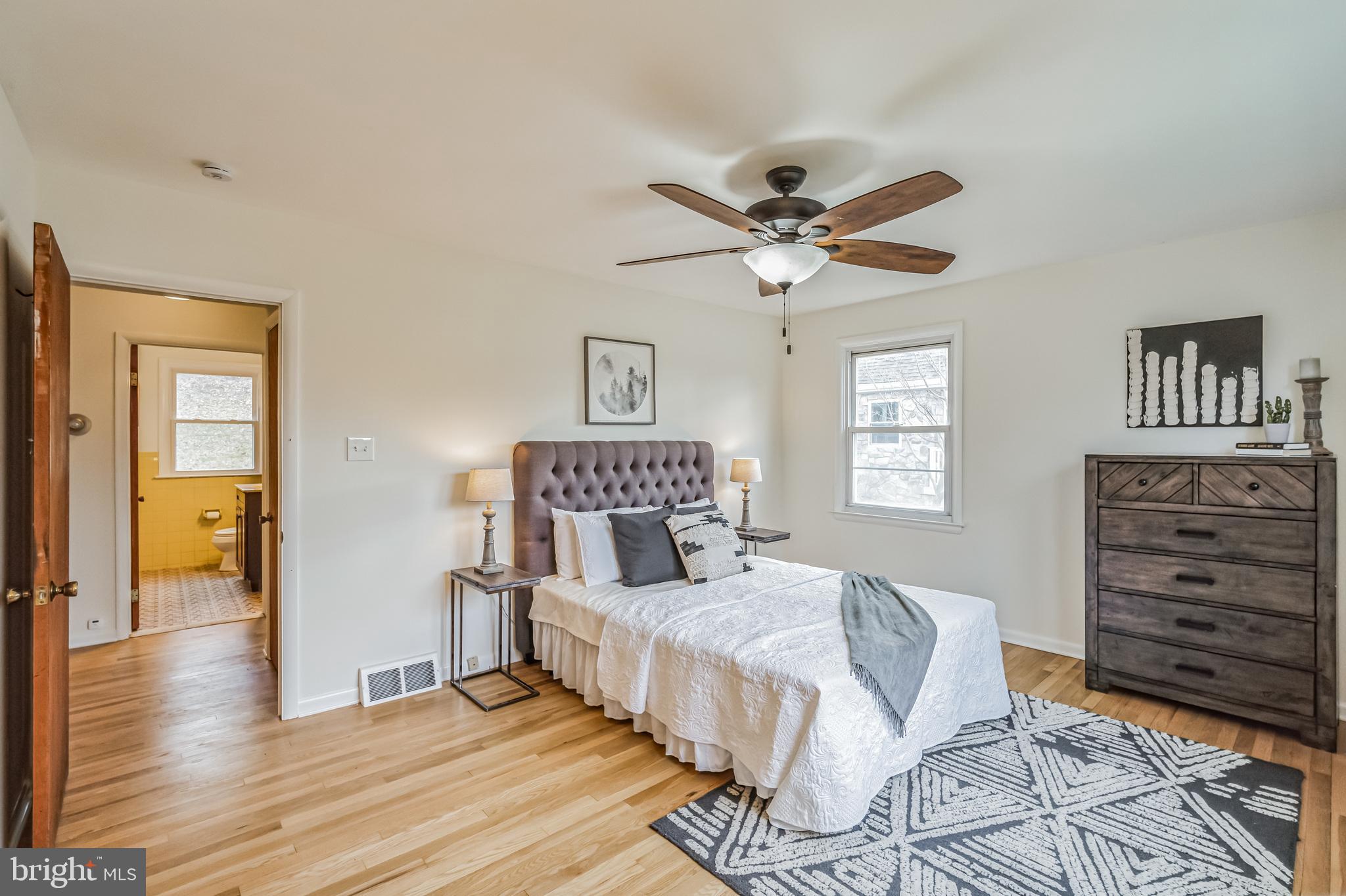 645 Glendale Road Havertown, PA 19083 - Photo 14 of 36 a bedroom with a bed and a chandelier