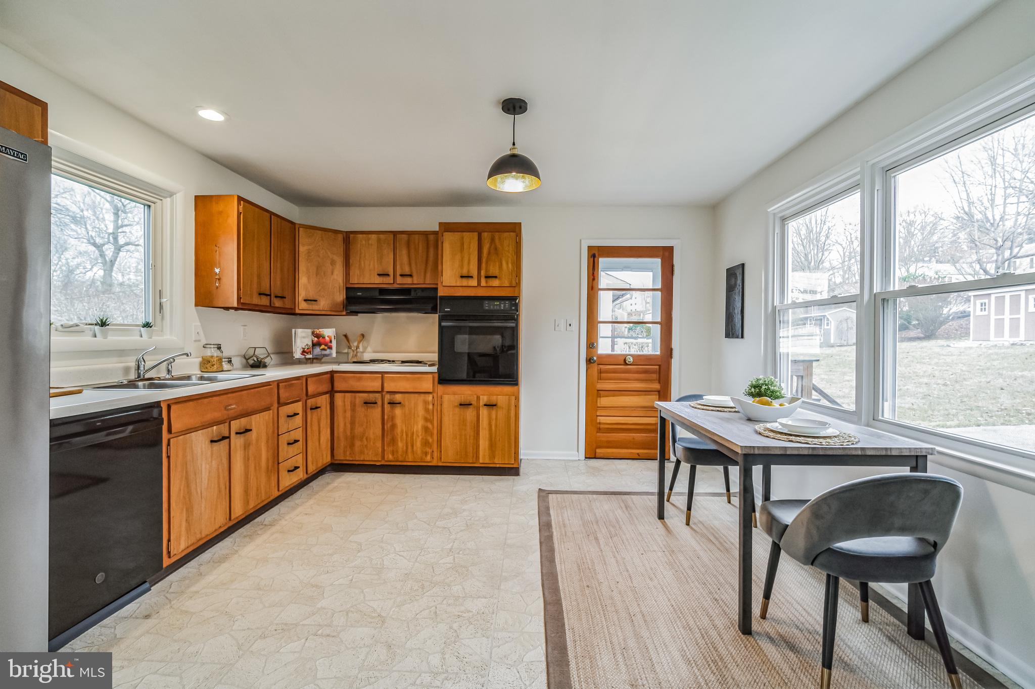 645 Glendale Road Havertown, PA 19083 - Photo 9 of 36 a kitchen with granite countertop a stove a sink a dining table and chairs