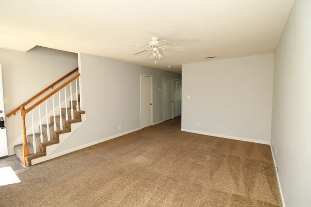 a view of an empty room with stairs