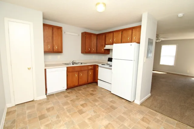 a kitchen with stainless steel appliances white cabinets and a refrigerator
