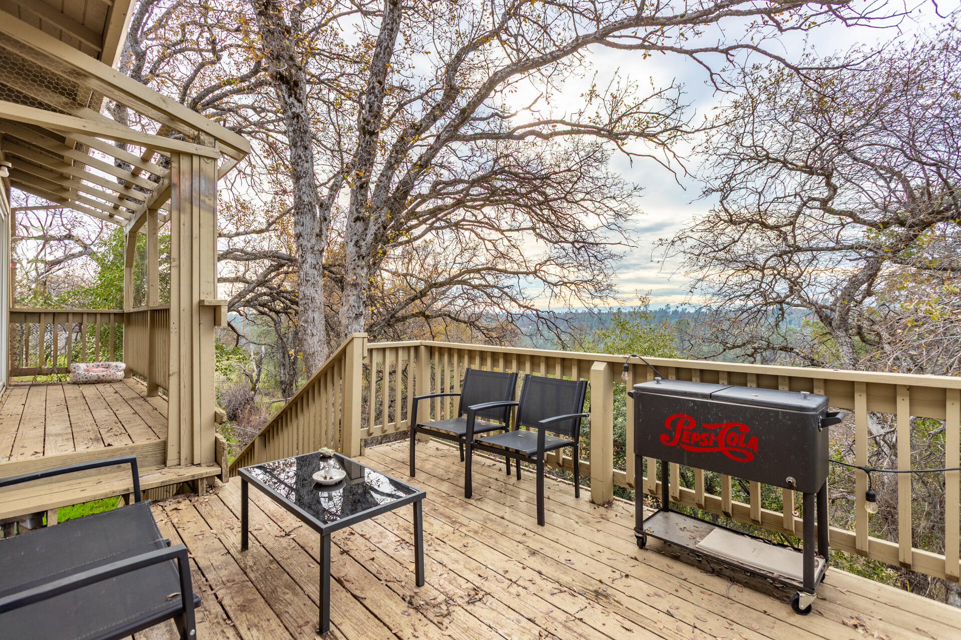 4720 Enchanted Way Redding, CA 96001 - Photo 14 of 19 a roof deck with table and chairs and wooden floor