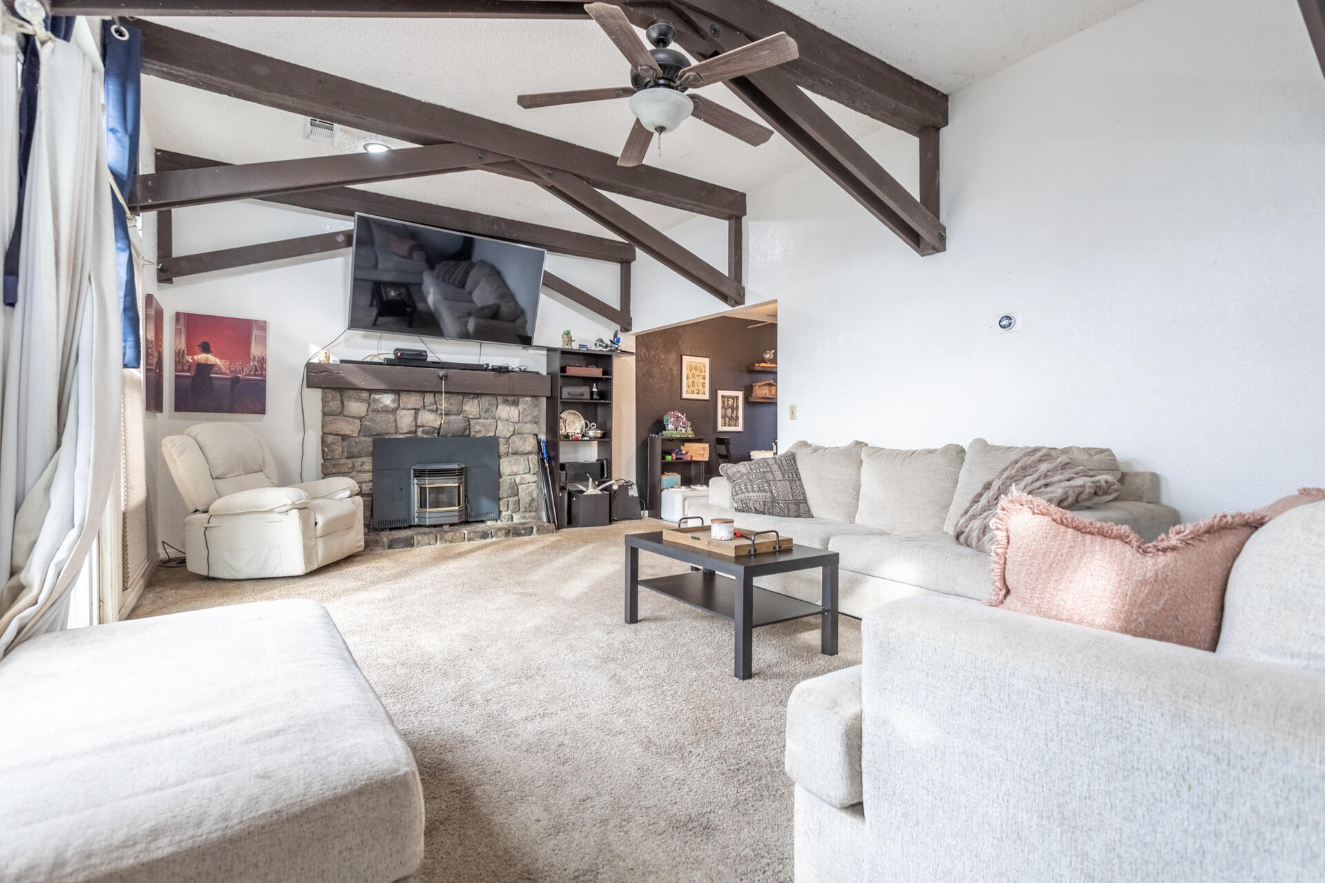 4720 Enchanted Way Redding, CA 96001 - Photo 3 of 19 a living room with furniture a fireplace and a flat screen tv