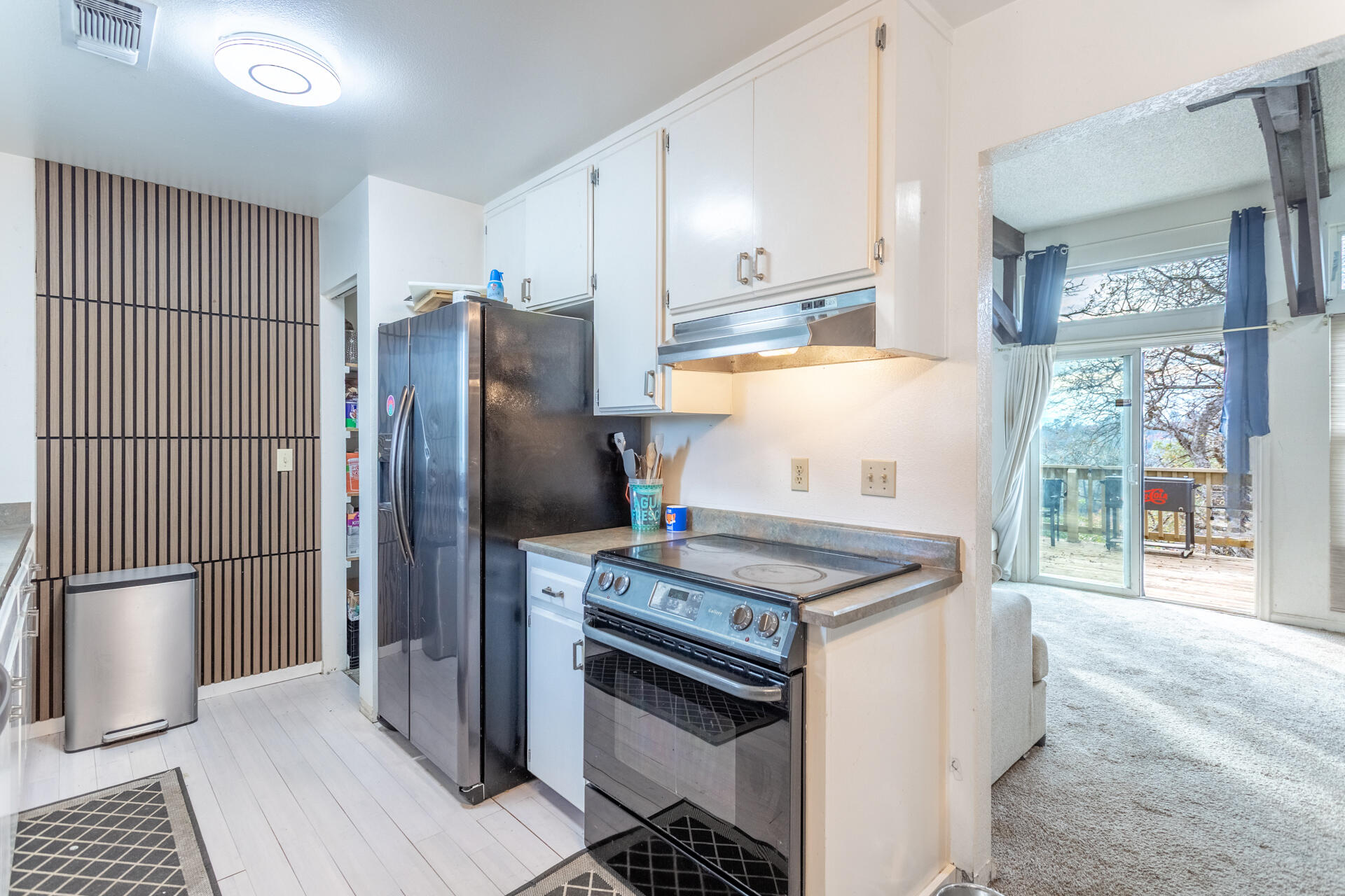 4720 Enchanted Way Redding, CA 96001 - Photo 8 of 19 a kitchen with stainless steel appliances granite countertop a stove a refrigerator and a wooden cabinets