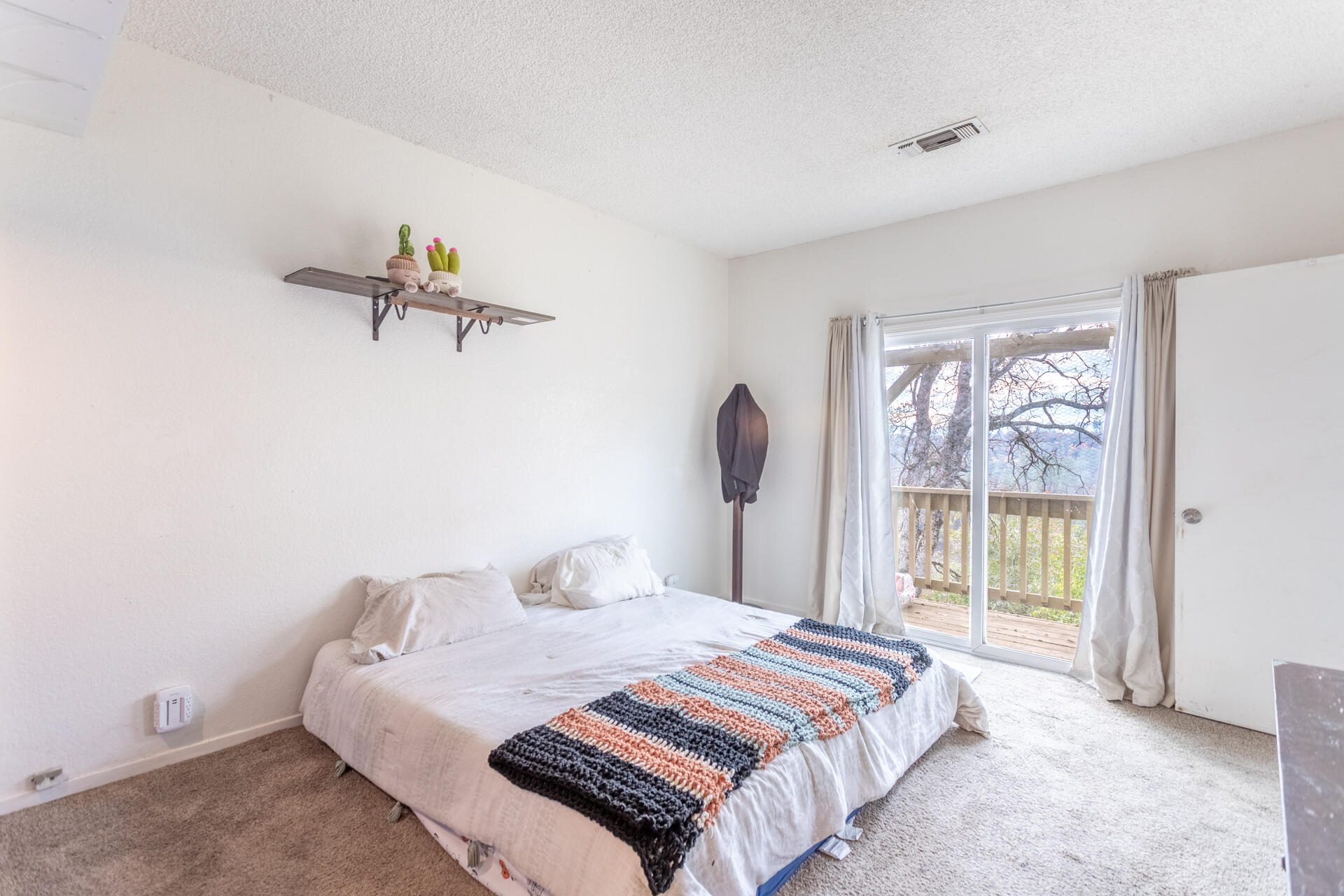 4720 Enchanted Way Redding, CA 96001 - Photo 9 of 19 a bedroom with a bed and a window