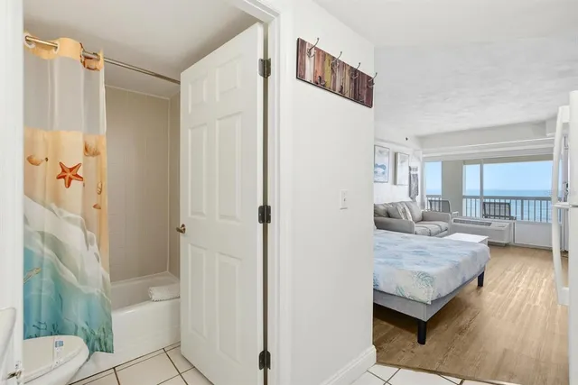 a en suite bathroom with a granite countertop sink and a mirror