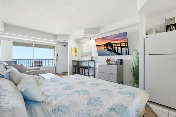 a bedroom with a large bed and a large window