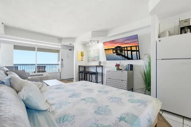 a bedroom with a large bed and a large window